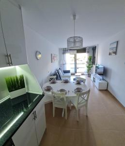 a kitchen and dining room with a table and chairs at Casa Soñada - Dream House in Garrucha