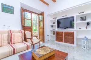 a living room with a couch and a tv at Finca Son Punta in Felanitx