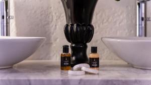 two bottles of essential oils on a counter next to a sink at Amon Hotels Belek - Adult Only in Belek