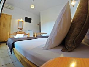 a bedroom with a large white bed with pillows at Studios Filippina in Skala Potamias