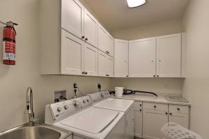 a kitchen with white cabinets and a sink at Charming Murphy House with Deck & River Views! in Murphy +44 photos