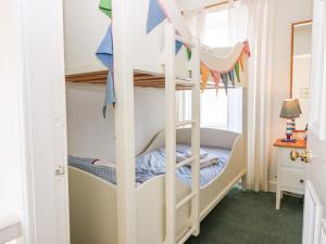 a bunk bed in a childs room with a ladder at 16 Westgate South in Anstruther