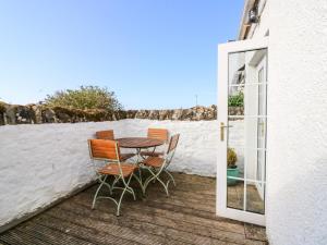 a patio with a table and chairs on a balcony at 16 Westgate South in Anstruther