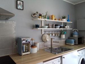 a kitchen with a counter with a toaster and a microwave at Le Gîte du Lapin Bleu in Baigneux-les-Juifs +23 photos