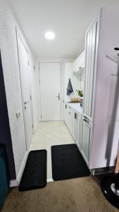 a room with a hallway with a door and a kitchen at Ski INN Atrium Gudauri in Gudauri