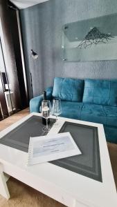 a living room with a white table and a blue couch at Ski INN Atrium Gudauri in Gudauri