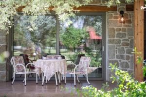a table and chairs on a patio with a window at Villa Menie - Golden Fig Sykia lodge in Paralia Sikias +53 photos