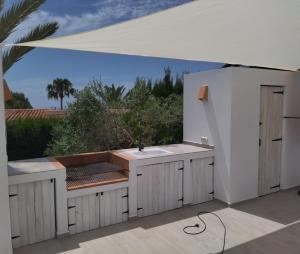 a white kitchen with a sink and a view at Villa Martí in Calpe