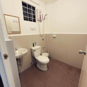 a bathroom with a toilet and a sink at Sto Niño Residences Lucena City in Lucena