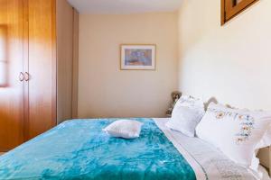 a bedroom with a large blue bed with white pillows at Stella in Panasós