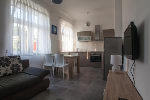 a living room with a couch and a dining room at Apartments Svilan in Trogir