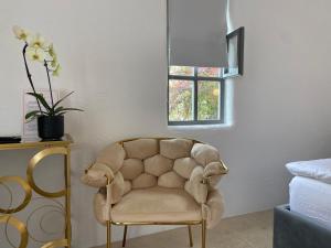 a chair sitting in a room with a window at Tagoo Vama Veche in Vama Veche
