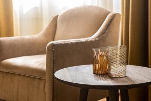 a chair and a table with a glass on it at Hotel Dei Dragomanni in Venice