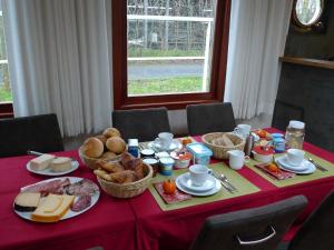 a table with a red table cloth with food on it at B&B Barge Johanna in Bruges