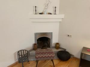 a living room with a fireplace and a table and chairs at Hotel Lemi in Mestia