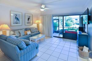 a living room with a couch and a tv at COQUINA 3C in Sanibel