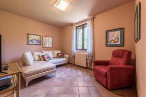a living room with a couch and a chair at Casa Vacanze Matisse in Toscolano Maderno