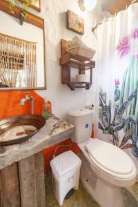 a bathroom with a toilet and a sink at Finca Los Abuelos - La Planta in Concepción