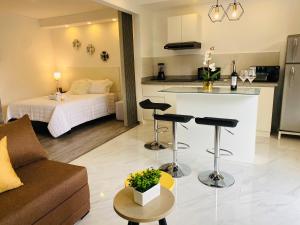 a living room with a kitchen and a room with a bed at Alba de las Sierras in Cuenca