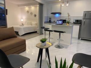 a kitchen and living room with a couch and a table at Alba de las Sierras in Cuenca