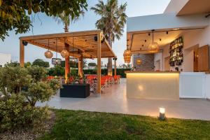 a patio with a bar with orange chairs at Cirillo Family Hotel-Christinas Studios in Mastihari