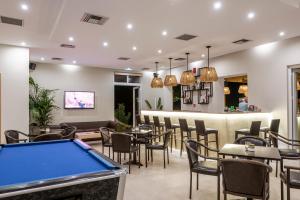 a pool table in a restaurant with a bar at Cirillo Family Hotel-Christinas Studios in Mastichari