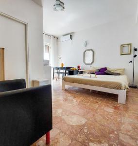 a bedroom with a bed and a table and a mirror at Tiny house via mascilongo in Termoli