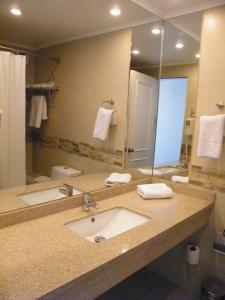 a bathroom with a sink and a large mirror at Hotel Antofagasta in Antofagasta