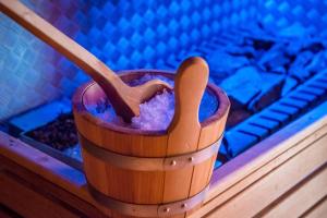 a wooden cup with a wooden spoon sitting on a table at Alpine Deluxe 2.0 in Riscone