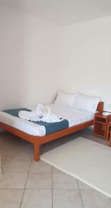 a bed with white sheets and pillows on it at Casa Carina in Jupiter