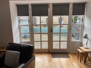 a living room with large sliding glass doors at Charming Barn Conversion on Private Estate in Symington