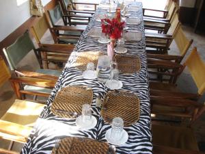 a long table with a black and white table cloth at Maasai Simba Camp in Amboseli