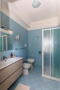 a bathroom with a toilet and a sink and a shower at B&B La Barcaccia in Tortora