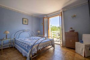 a bedroom with a bed and a sliding glass door at Large Spacious House In Fréjus in Fréjus +6 photos