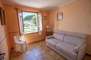a living room with a couch and a window at Large Spacious House In Fréjus in Fréjus