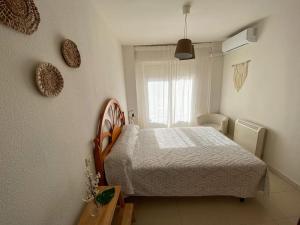 a small bedroom with a bed and a window at -. Villa Nena .- in Ledesma