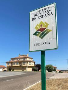a sign on the side of a road in front of a building at -. Villa Nena .- in Ledesma