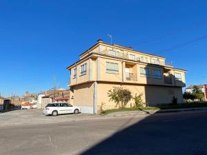 a white car parked in front of a building at -. Villa Nena .- in Ledesma
