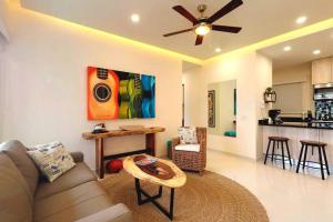 a living room with a couch and a ceiling fan at Nayri Life 509 in Puerto Vallarta