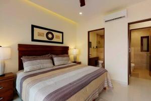 a bedroom with a large bed and a bathroom at Nayri Life 509 in Puerto Vallarta +40 photos