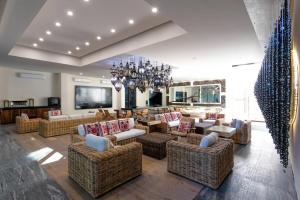 a large living room with couches and a chandelier at Nayri Life 509 in Puerto Vallarta