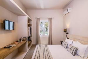 una camera d'albergo con letto e TV di Hotel Eucalyptus a Mesariá