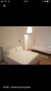 a bedroom with a white bed and a light at Center, 15 minutes from Venice, Parking Miranese in Mestre