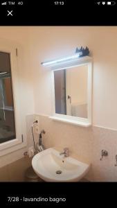 a bathroom with a white sink and a mirror at Center, 15 minutes from Venice, Parking Miranese in Mestre +20 photos