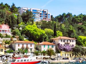 a group of boats in a marina with buildings at Silba - Luxury Apartment in Rabac