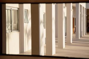 vistas al pasillo de un edificio con ventanas en Topia Retreat - Piscina Suite Norte, en El Pescadero