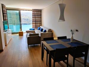 a living room with a table and a couch at Silba - Luxury Apartment in Rabac