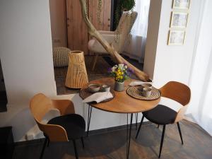 a dining room table with chairs and a table with flowers at Lieblingsnest in Schwerin +12 photos