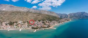 a small island with a red sign on it at Azra Apartments in Duće