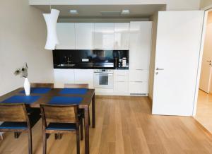a kitchen with a dining room table and chairs at Silba - Luxury Apartment in Rabac